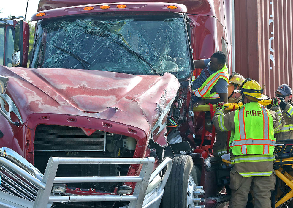 Spot News - 2nd placeSpringfield Township fire fighters help a semi truck driver onto a stretcher after they cut him free of his truck following a crash between three commercial trucks in the construction zone of westbound Interstate 70. The driver suffered non-life threatening injuries in the crash. The drivers of the two other trucks were not injured.  (Bill Lackey / Springfield News-Sun)