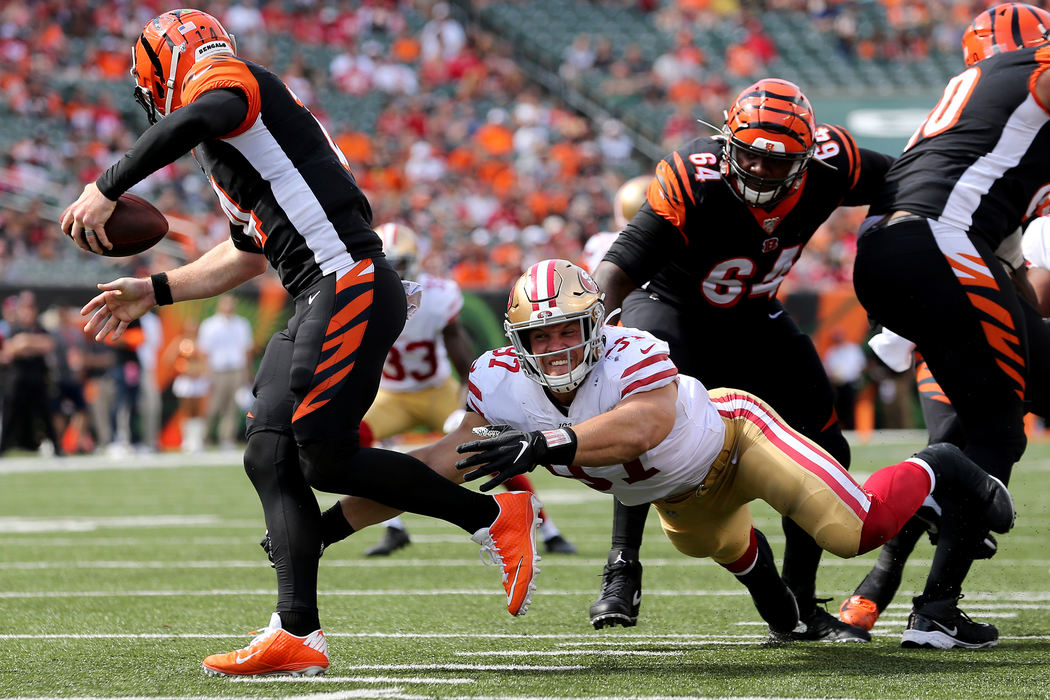 Sports - 2nd placeCincinnati Bengals quarterback Andy Dalton (14) escapes San Francisco 49ers defensive end Nick Bosa (97) in the fourth quarter at Paul Brown Stadium in Cincinnati.  (Kareem Elgazzar / The Cincinnati Enquirer)