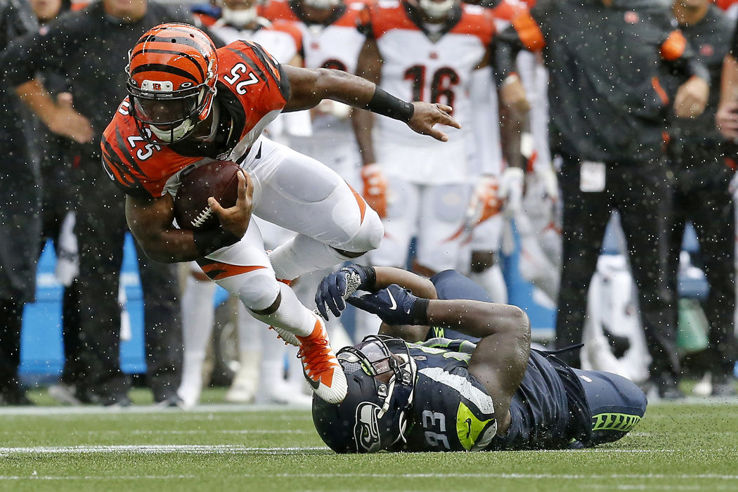 Sports - 3rd placeCincinnati Bengals running back Giovani Bernard (25) is tripped up by Seattle Seahawks defensive end Branden Jackson (93) on a carry in the third quarter at CenturyLink Field in Seattle. (Sam Greene / The Cincinnati Enquirer)