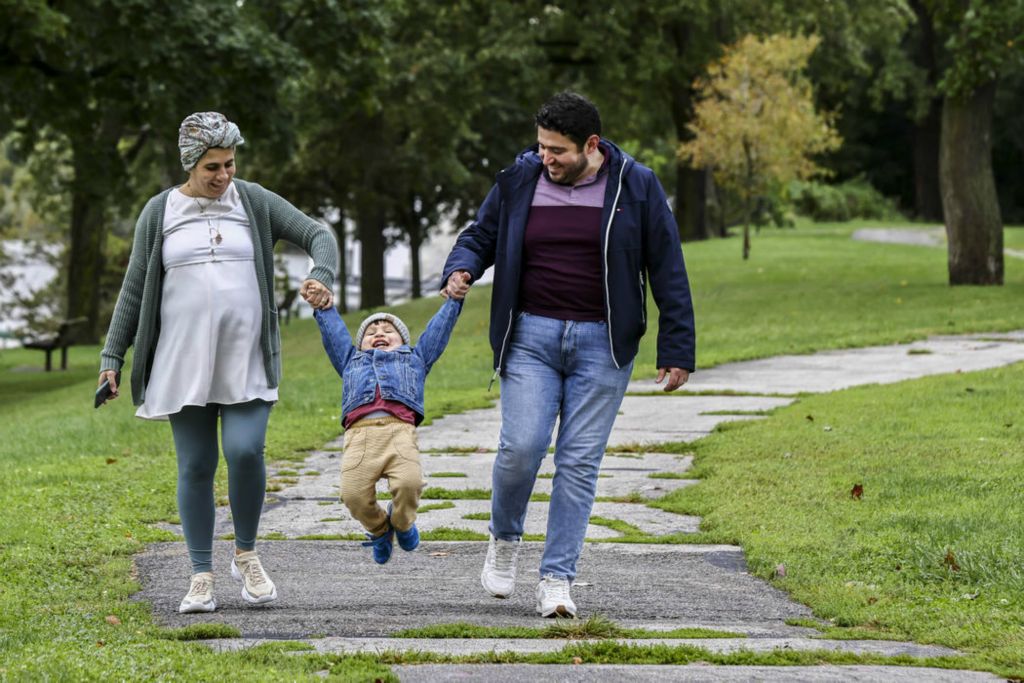 Feature - 3rd place - Sermin Dabjan and her husband Badi Dabjan of Bloomfield, Michigan, take a fall walk with their son Beibars, 2, at Walbridge Park in Toledo.  (Jeremy Wadsworth / The Blade)