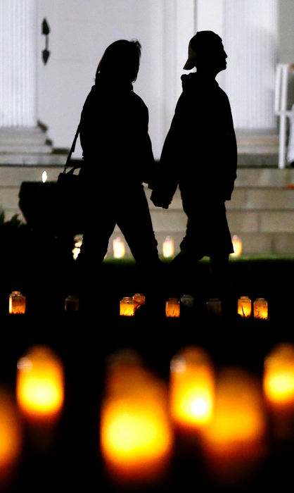 General News - 2nd place - A couple holds hands as they take in the 2,976 candles on display at the Tallmadge Circle on the 20th anniversary of the 9/11 terror attacks, Sept. 11, 2021, in Tallmadge. Every year the Tallmadge Fire Department lights a candle for every single person who died on 9/11 in the World Trade Center, Pentagon and Flight 93. (Jeff Lange / Akron Beacon Journal)