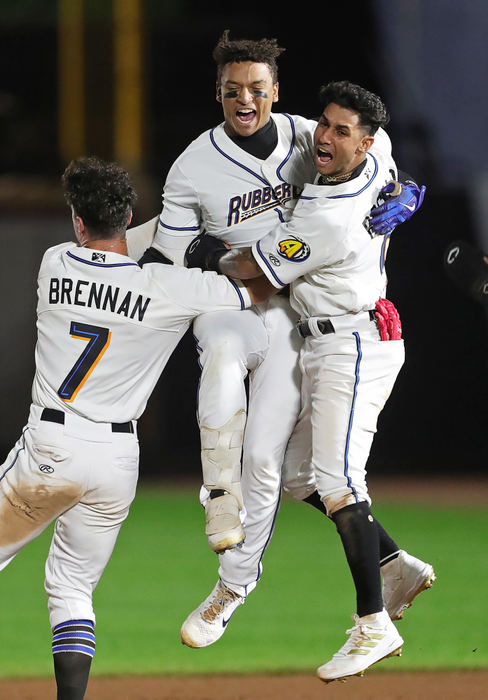 Sports Feature - 1st place - Akron RubberDucks catcher Bo Naylor (12) celebrates with outfielder Will Brennan (7) and infielder Brayan Rocchio (9) after hitting a walk-off base hit to clinch the Class AA Northeast Championship at Canal Park in Akron. (Jeff Lange / Akron Beacon Journal)