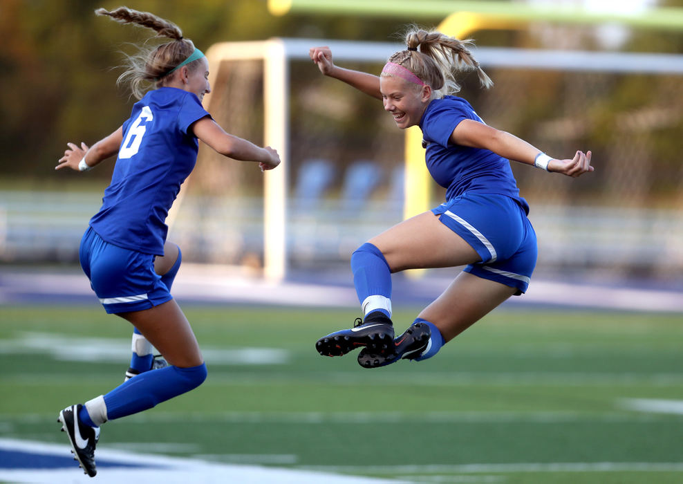 Sports Feature - 3rd place - Hilliard Davidson's Kate Kodger (6) and Elizabeth Wile (8) go through a routine during player introductions before a game against New Albany at Hilliard Davidson High School in Hilliard. (Shane Flanigan / ThisWeek Community News)