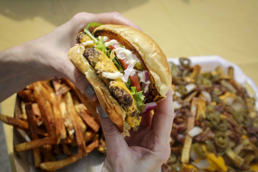 Illustration - 3rd place - Mary Bilyeu gets the All American burger from the Beastro Burger food truck at Patron Saints Brewery in West Toledo for Cheap Eats, the series that finds the best dining deals for $10 and under. (Phillip L. Kaplan / The Blade)