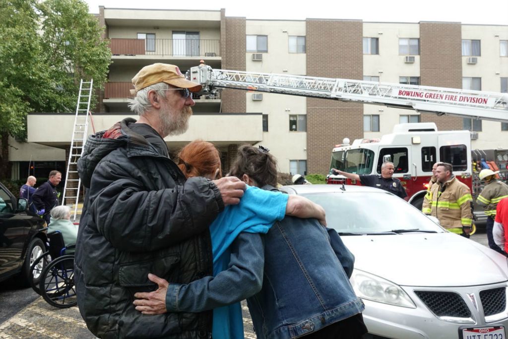 Spot News - 1st place - Fairview Manor residents look on while members of the Bowling Green Fire Division battle a blaze at the apartment complex located at 1020 N. Grove St. in Bowling Green, Ohio. There were a couple minor injuries, including to the person in the apartment where the fire started, according to Bowling Green Police Division Chief Tony Hetrick. (J.D. Pooley / Sentinel-Tribune )