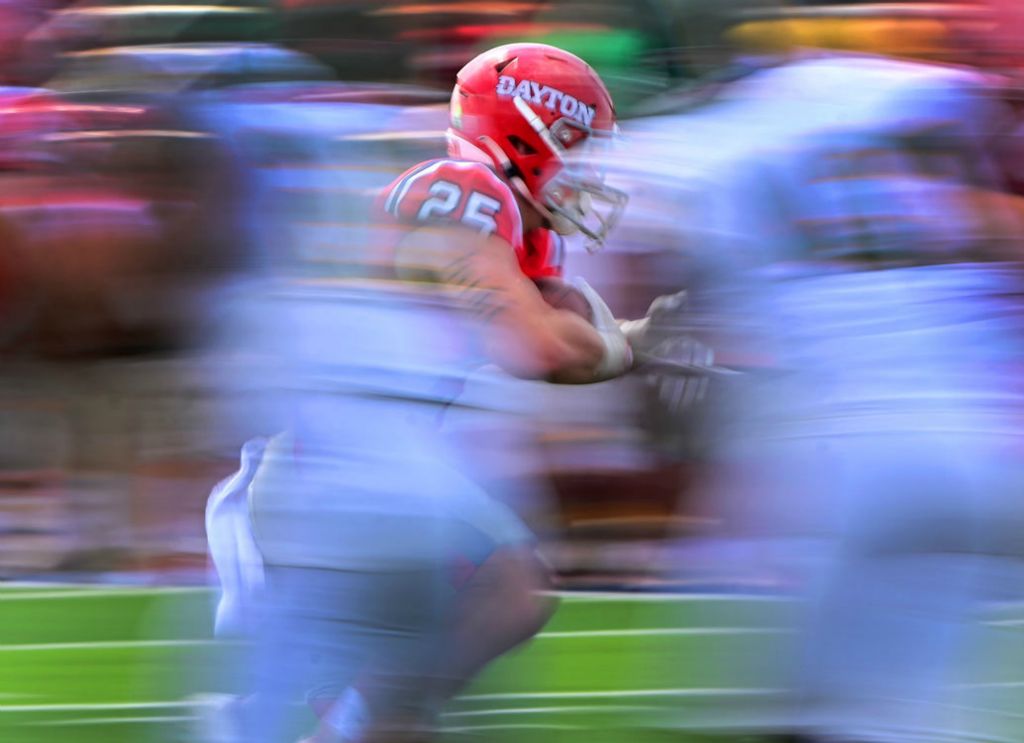 Sports - 2nd place - Dayton's Logan Davis carries the ball against Kentucky State at Welcome Stadium in Dayton. Dayton defeated Kentucky State 46-3 (Erik Schelkun)