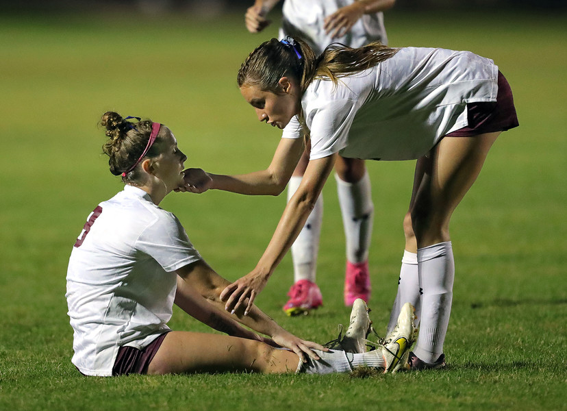 Sports Feature - HM - Walsh Jesuit midfielder Reagan Pentz (left) is comforted by forward Ciara Santiago after the Warriors tied, 1-1, with the Strongsville Mustangs in a soccer match in Strongsville. (Jeff Lange / Akron Beacon Journal)