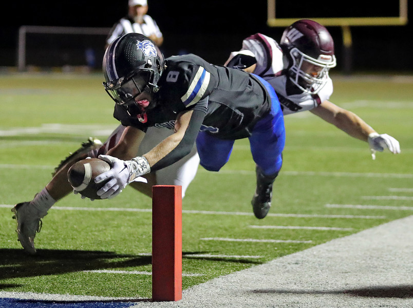 Sports - 1st place - CVCA’s Ryan Wiehe dives toward the pylon to score a two point conversion against Woodridge during the second half of a high school football game in Cuyahoga Falls. (Jeff Lange / Akron Beacon Journal)