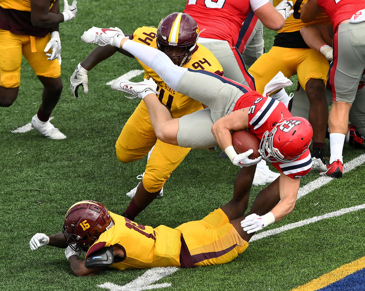 Sports - HM - Dayton's Logan Davis dives for yardage during the third quarter against Central State. Dayton defeated CSU 62-24 at Welcome Stadium in Dayton. (Erik Schelkun / Elsestar Images)