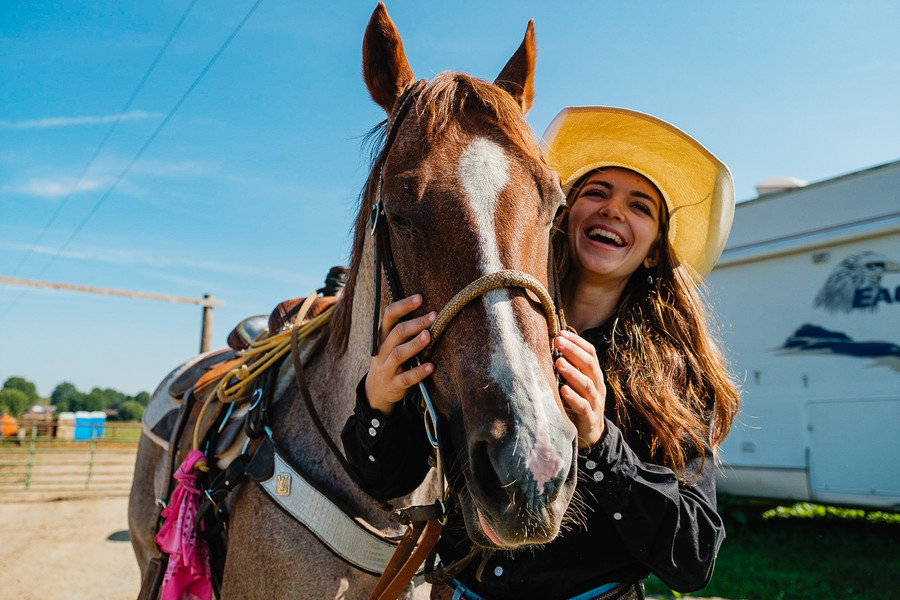 Portrait - 2nd place - Hadassa Mullett, 18, shares a laugh with her father (off camera) while embracing Boomer, a 16-year-old quarter horse, at the family-owned Smokey Lane Stables, in Sugarcreek. Hadassa is currently exploring a career in rodeo, and will compete at this year's Tuscarawas County Fair, in Dover. (Andrew Dolph / The Times Reporter)