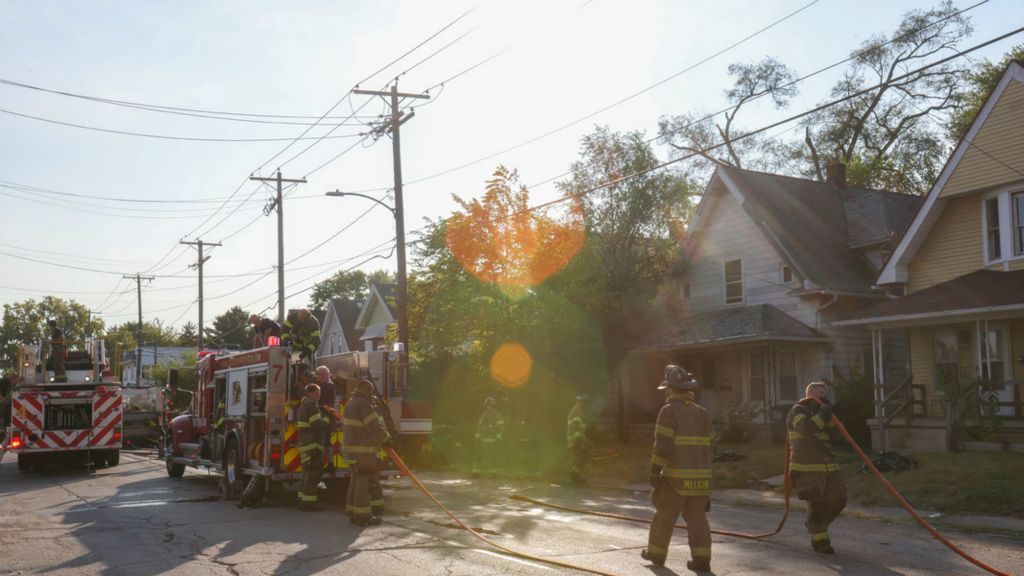 Spot News - 2nd place - Toledo Firefighters put away their hoses after fighting a house fire at 760 Spencer Street. (Jonathan Aguilar / The Blade)