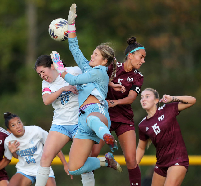 Sports - 1st place - Walsh Jesuit goalkeeper Ava DeBolt (center) hits a corner kick away over Hudson’s Delaney Halstead and teammate Hannah Pachan during the first half of a high school soccer match in Cuyahoga Falls. (Jeff Lange / Akron Beacon Journal)