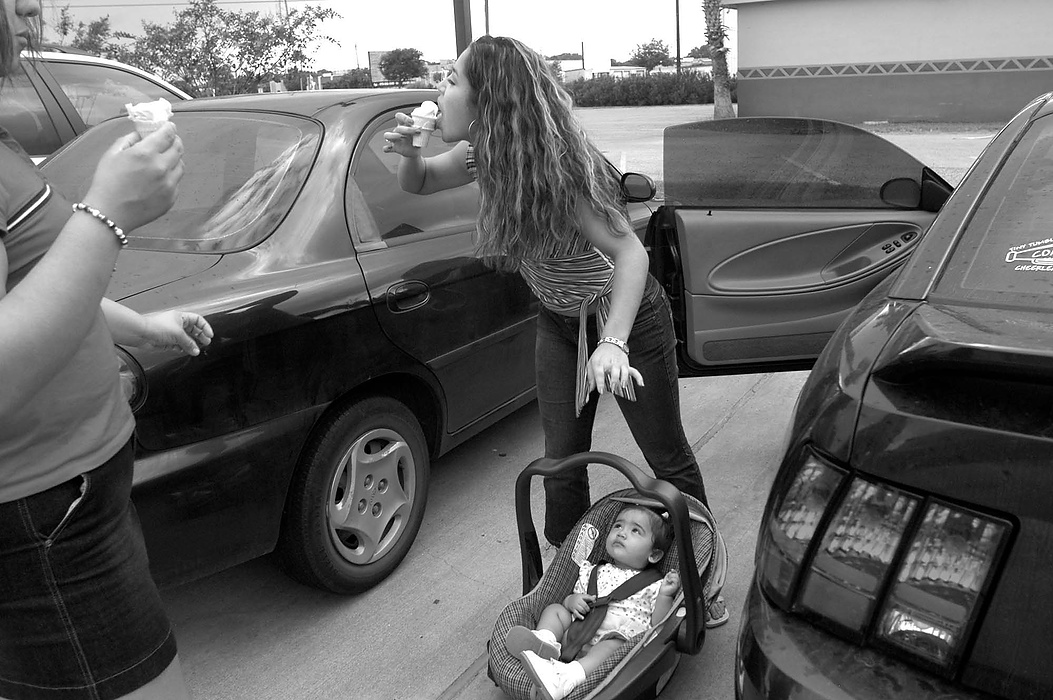 Second place, Larry Fullerton Photojournalism Scholarship - Erin Galletta / Kent State UniversityOn a Saturday while babysitting, Vanessa Silva, 17, takes a moment to stop the drips of ice cream before getting baby Aaliah situated in the car. Aaliah's parents are both juniors at Brazosport High School in Freeport, Texas.