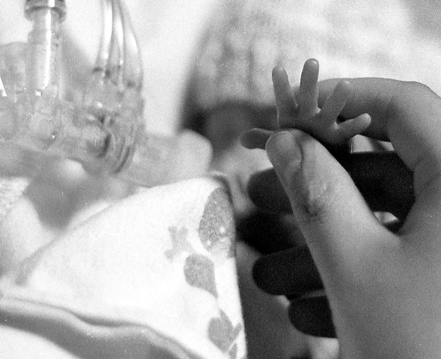 First place, Larry Fullerton Photojournalism Scholarship - Lindsay Steiner / Ohio UniversityCasi holds Isabella's tiny hand while she spends an evening at the hospital.  Isabella is now a little over three pounds.  