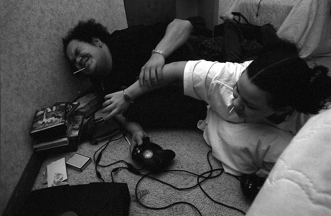 First place, Larry Fullerton Photojournalism Scholarship - Lindsay Steiner / Ohio UniversityCasi and Ricky playfully fight over a game of Tetris at their room in the Ronald McDonald House.  Despite their new parental roles, they still try to keep their childhood alive by playing video games and other leisure activities. 