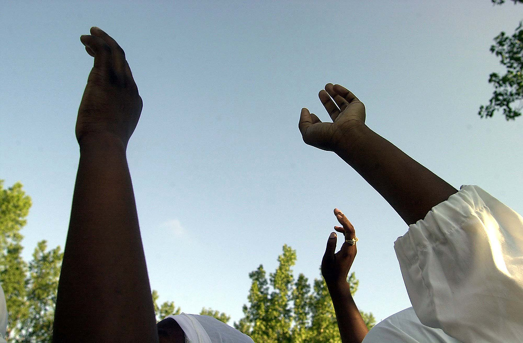 First place, Larry Fullerton Photojournalism Scholarship - Lindsay Steiner / Ohio UniversityMembers of the New Morning Star Missionary Baptist Church raise their hands in prayer before a full immersion baptism.