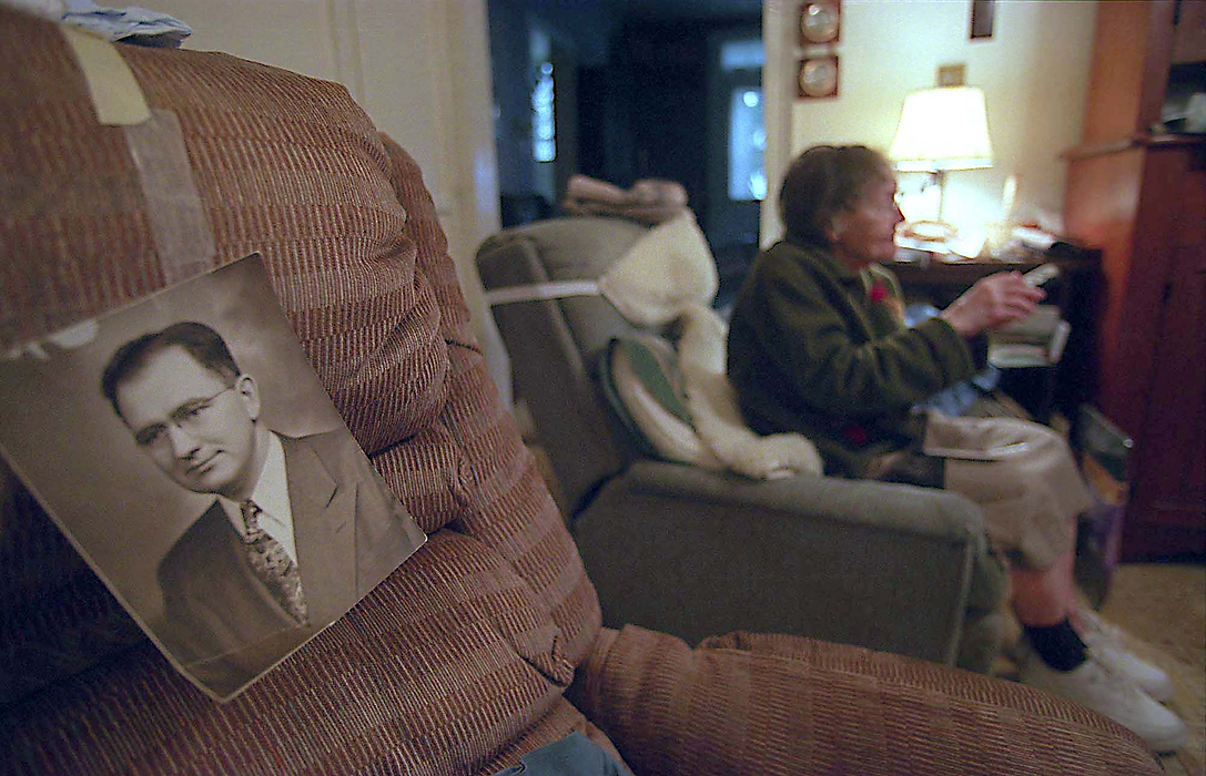 First place, Larry Fullerton Photojournalism Scholarship - Lindsay Steiner / Ohio UniversityMargaret struggles with her remote control and tries to find something on the television to watch.  She has taped a photograph of Nelson to the easy chair that he used to sit in.  She says that learning how to use the television is new and difficult for her since Nelson was always in control of the remote.  She is now learning to live a life alone.  "I miss him so much.  I talk to him every day, and he talks to me," as Margaret quietly sighs. 