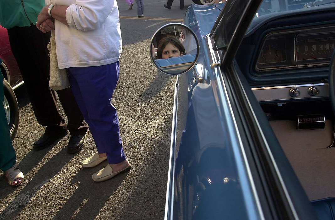 First place, Larry Fullerton Photojournalism Scholarship - Lindsay Steiner / Ohio UniversityAshlin Gable, 9, peers out from a 1966 Chevrolet during the Bluffton Festival of Wheels car show. 