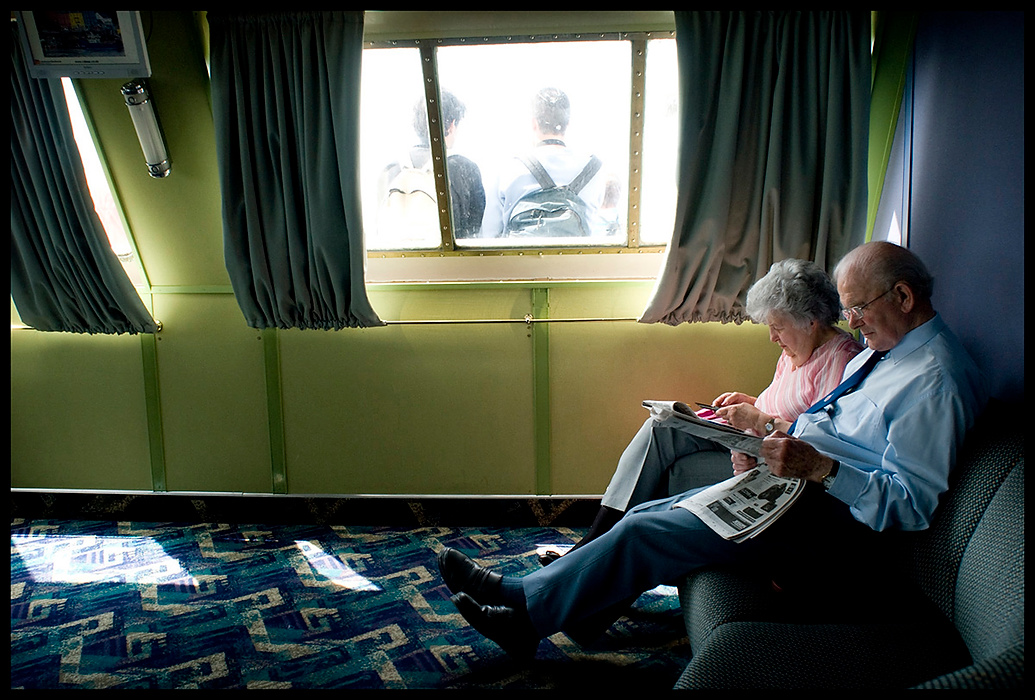 Larry Fullerton Photojournalism Scholarship - James Roh / Ohio UniversityHettie and Graham Hood read the newspaper on the ferry as they cross the Firth of Clyde waiting to arrive on the Isle of Arran's main city, Brodick.  The Hood's lived on the island for 25 years before moving to another island just north of Arran.  They were traveling to Arran to visit and stay with friends on Arran. 