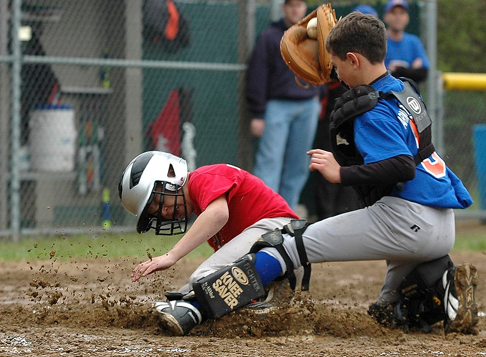 Larry Fullerton Photojournalism Scholarship - Laura Torchia / Kent State UniversityBrandon Daniels, 11, of Massillon is called safe at home plate in Saturday's little league opening day game.