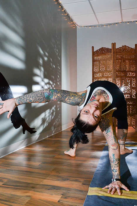 Second Place, Larry Fullerton Photojournalism Scholarship - Madison Schmidt / University of CincinnatiTracy Baer, owner of Yoga 33 in Western Hills, holds the "wild thing" pose while performing a warm down Ashtanga routine in her studio. 