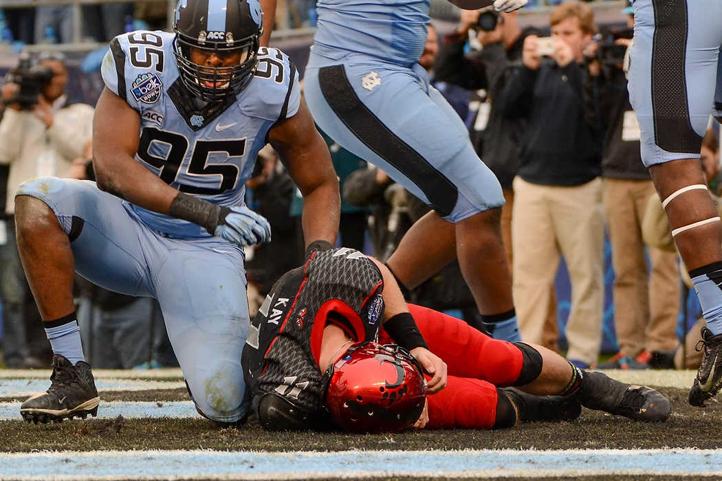 Second Place, Larry Fullerton Photojournalism Scholarship - Madison Schmidt / University of CincinnatiQuarterback Brendon Kay lies in the Cincinnati end zone after North Carolina's safety score in the first half at the Bank of America Stadium in Charlotte, NC. Bearcats lost 17-39 against the Tar Heels during the 2013 Belk Bowl. 