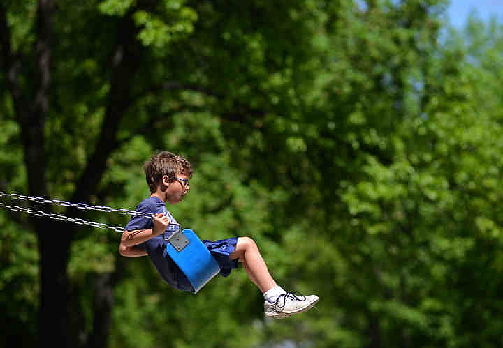 First place, Larry Fullerton Photojournalism Scholarship - Jenna Watson / Kent State UniversityCaleb Landcaster, 7, swings after taking part in a luncheon at University Park in Grand Forks, N.D., a meal provided by volunteers at St. Joseph's Social Care and Thrift Store. 