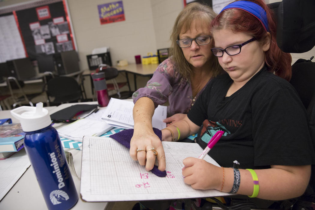 Second place, Larry Fullerton Photojournalism Scholarship - Alex Driehaus / Ohio UniversityTracie Jordan, a paraprofessional at Alexander Schools who helps Adyn with tasks throughout the day, works with her on math classwork. Certain concessions are made for Adyn, like allowing her to use a dry erase board and occassionaly a laptop, in order to make it easier for her to complete her schoolwork. 