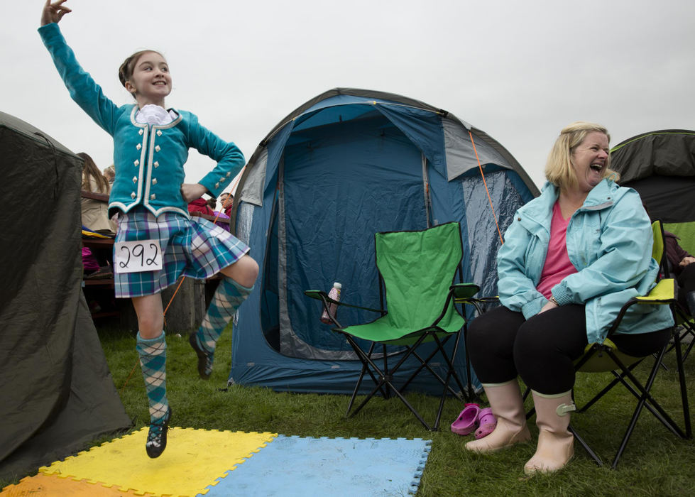 Second place, Larry Fullerton Photojournalism Scholarship - Alex Driehaus / Ohio UniversityWendy Kirk laughs as she talks to a friend while her daughter Erynn practices before a highland dance competition at the Bridge of Allan Highland Games in Bridge of Allan, Scotland. 