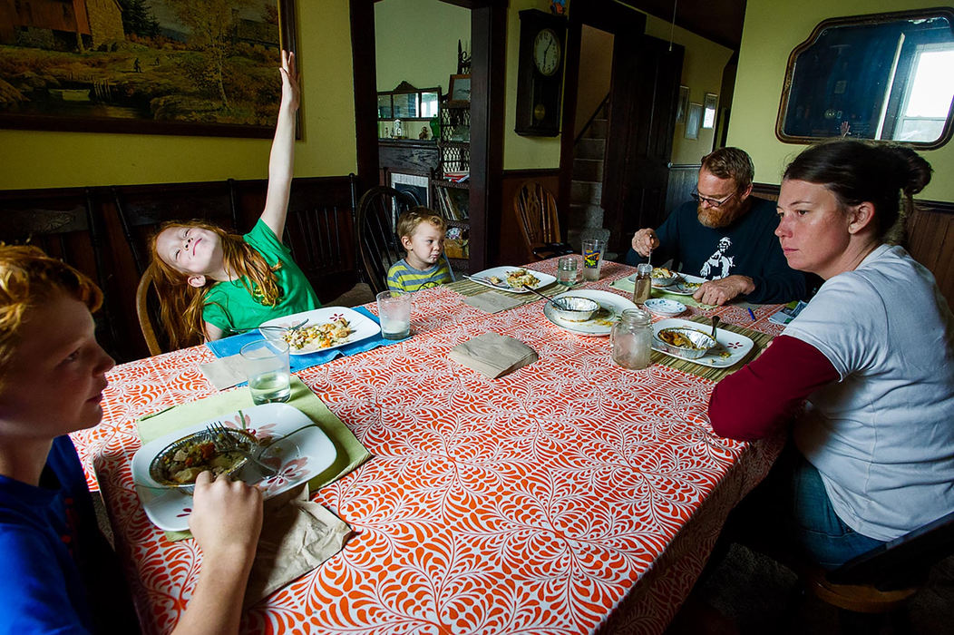 First place, Larry Fullerton Photojournalism Scholarship - Sarah Stier / Ohio UniversityFrom left, Edgar, 11, Lilah, 6, Harlan, 4, Nick, and Celeste sit down for a lunch of chicken pot pie at their farmhouse in Gallipolis. Lilah tries to grab her parents' attention by goofing off.