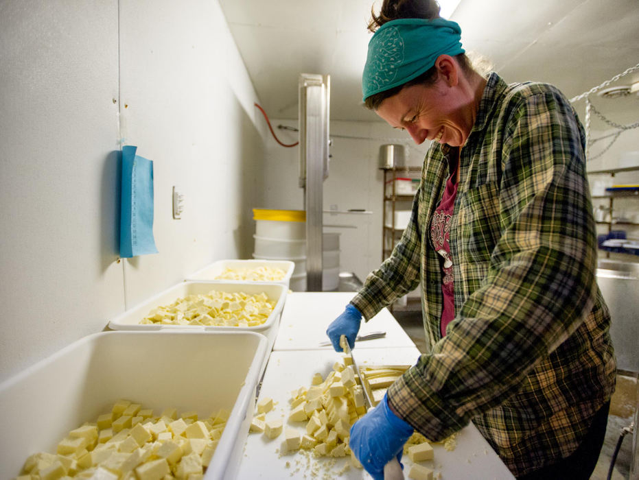 First place, Larry Fullerton Photojournalism Scholarship - Sarah Stier / Ohio UniversityCeleste Nolan cuts large blocks of curd into smaller curds  at Laurel Valley Creamery in Gallipolis. Nolan will deliver packages of cheddar curds to Athens restaurants and farmers markets later in the week.  