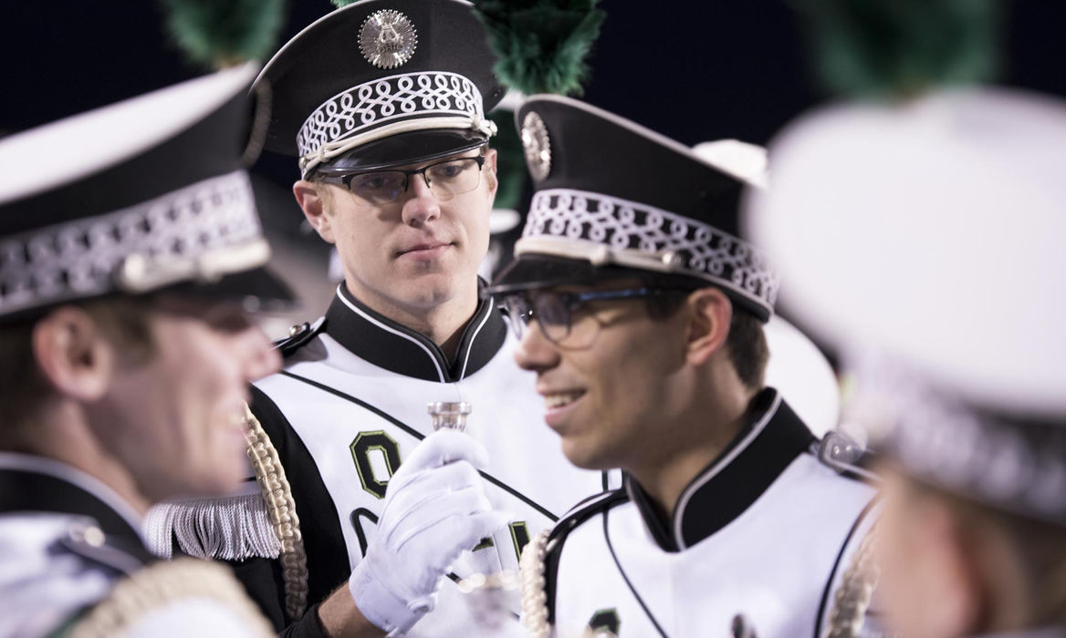 First Place, Larry Fullerton Photojournalism Scholarship - Alexandria Skowronski / Ohio UniversityCorey Machen (middle) and Colten Allen (right) prepare to take the field at Peden Stadium with fellow Marching 101 members during Ohio University's game against Miami University. 