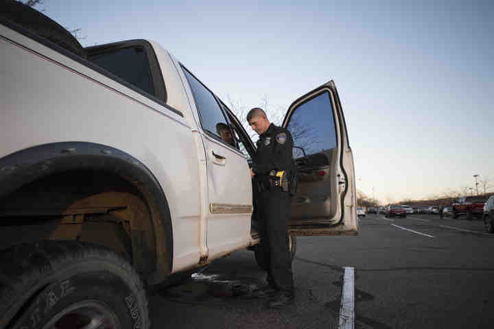 Third place, , Larry Fullerton Photojournalism Scholarsahip - Alexandria Skowronski / Ohio UniversityOfficer Andy Foster and the old truck left in Lowes parking lot since the weekend before Homecoming 2017 until December 1, 2017. (Alexandria Skowronski/Ohio University)