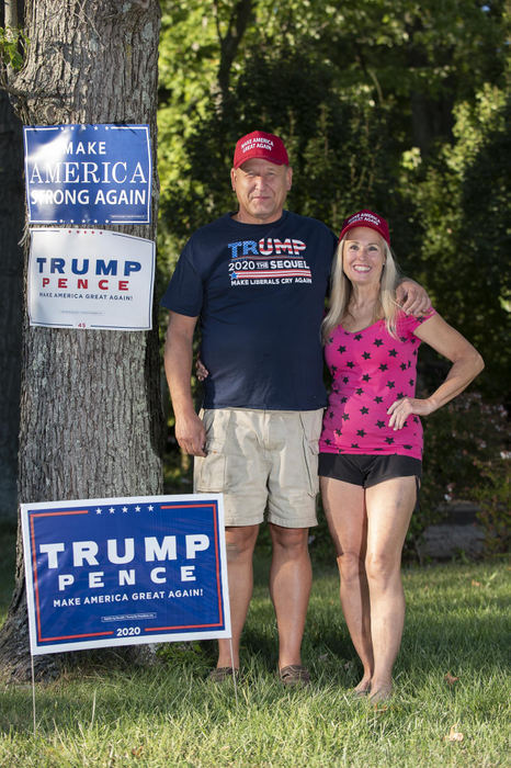 First Place - Larry Fullerton Photojournalism Scholarship , Tanner Pearson / Ohio UniversityKen and Chris Koncelik, of Cleveland pose in their front yard with their Trump signs in Mason, on Sept. 18, 2020. Ken Koncelik looks at his politics through the lens of running his business. Whoever is in office, deeply affects how his year goes. “The only three layoffs I’ve ever had to do where between 2008 and 2016. The best years I have had has been the past 3 years” says Ken. Chris looks through a broader political lens when it comes to what Trump wants to do. “Trump: promises made, promises kept. 