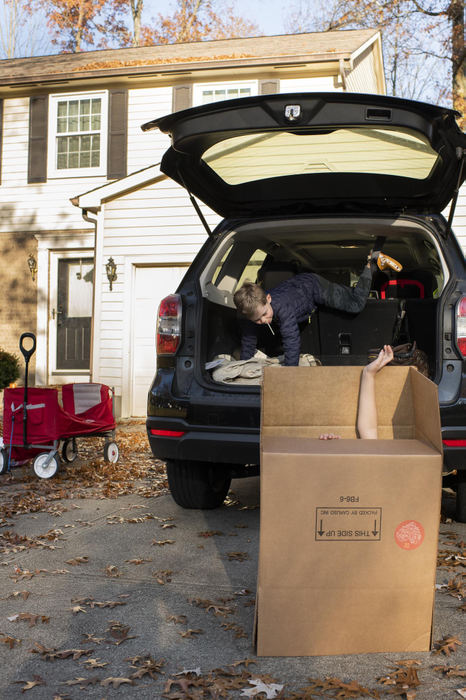 First Place - Larry Fullerton Photojournalism Scholarship , Tanner Pearson / Ohio UniversityLuke Mason climbs out of the back of the family car, while his sister, Natalie plays in a box on Nov. 11, 2020. The box is used by the Mason family to fill up with food supplies for the upcoming thanksgiving holiday to be donated to families through their church. “Mason does a nice job from a community standpoint of up keeping the area and also attract a lot of businesses that make it a desirable location” said Lauren Mason, their mom. “We were initially drawn to Mason for the school district that has consistently been highly ranked and has a lot of opportunities available for children as they progress.”