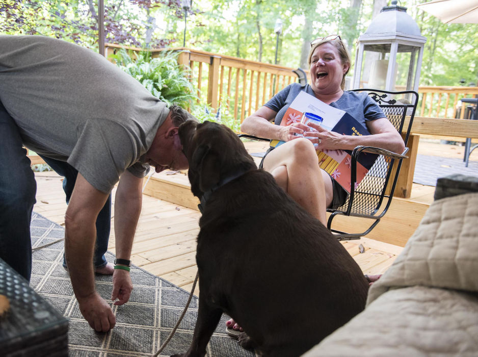 First Place - Larry Fullerton Photojournalism Scholarship , Tanner Pearson / Ohio UniversityPalmer licks Tim McDonald on the head while Melissa Pearson laughs on Sept. 3rd, 2020. The three love to spend the afternoons outside on the deck patio enjoying the weather.