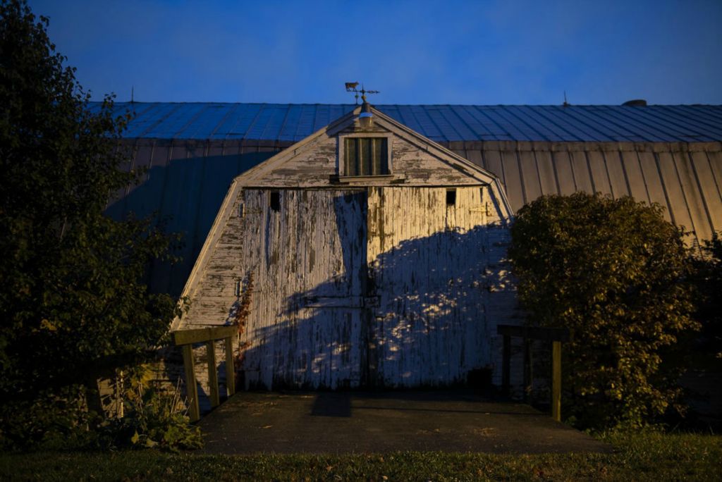 First Place - Larry Fullerton Photojournalism Scholarship , Tanner Pearson / Ohio UniversityThe Hy Vue barn on Oct. 21, 2020. The barn is two tiered. The top holds hay, while the bottom holds cattle in the winter as well as farm equipment. When Becky was growing up, the family could fit around 8,000 square bales of hay in the upper part of the barn. “We would have so much hay in here you could climb up and touch the ceiling” said Becky. Chutes were cut out of barn walls to allow hay to be thrown down to cattle.