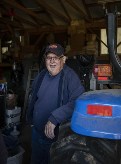 Second Place - Larry Fullerton Photojournalism Scholarship , Grace Wilson / Ohio UniversityMike Wilson stands next to his tractor, given to him by Karen's father, Bill Clevelle, when he passed away in 2005.