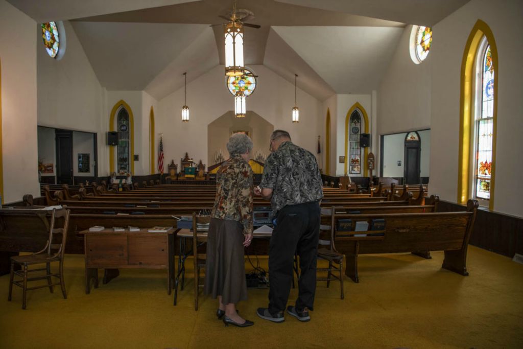 Second Place - Larry Fullerton Photojournalism Scholarship , Grace Wilson / Ohio UniversityKaren and Mike prepare for church on Nov. 8, 2020.  Karen turns all of the lights on and waters the flowers, while Mike gets the sound system set up and rings the bell. 