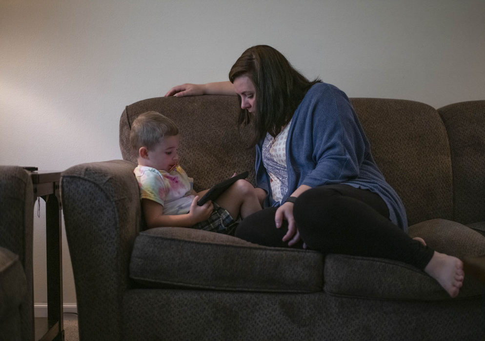 Second Place - Larry Fullerton Photojournalism Scholarship , Grace Wilson / Ohio UniversityKait sits with Bearett as he plays an educational game on this iPad. Before COVID, Kait worked as a drug counselor. She has found the transition from a working mom to a stay-at-home-mom to be very difficult, she says, "I often struggle with feeling appreciated and confident in my role."