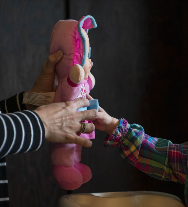 Second Place - Larry Fullerton Photojournalism Scholarship , Grace Wilson / Ohio UniversityCait hands a doll to her daughter, Abigail.