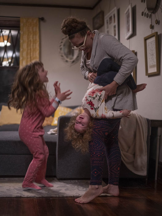 Second Place - Larry Fullerton Photojournalism Scholarship , Grace Wilson / Ohio UniversityCait plays with her two daughters, Caroline and Abigail after dinner.