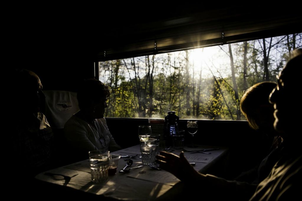 Second Place - Larry Fullerton Photojournalism Scholarship -  Passengers riding the Cuyahoga Valley Scenic Railroad enjoy talking and sipping on wine on the dinner train on May 14th, 2021 in Peninsula. (Ryan Grzybowski - Ohio University)  