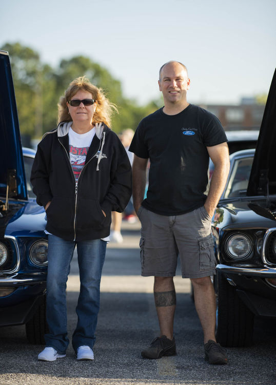 Second Place - Larry Fullerton Photojournalism Scholarship -  Mother and Son, Wendy and Mike Von Duhn stand next to their 69 Ford Mustangs at a Car show in Parma Heights, Ohio on September 11, 2020. (Ryan Grzybowski - Ohio University)  