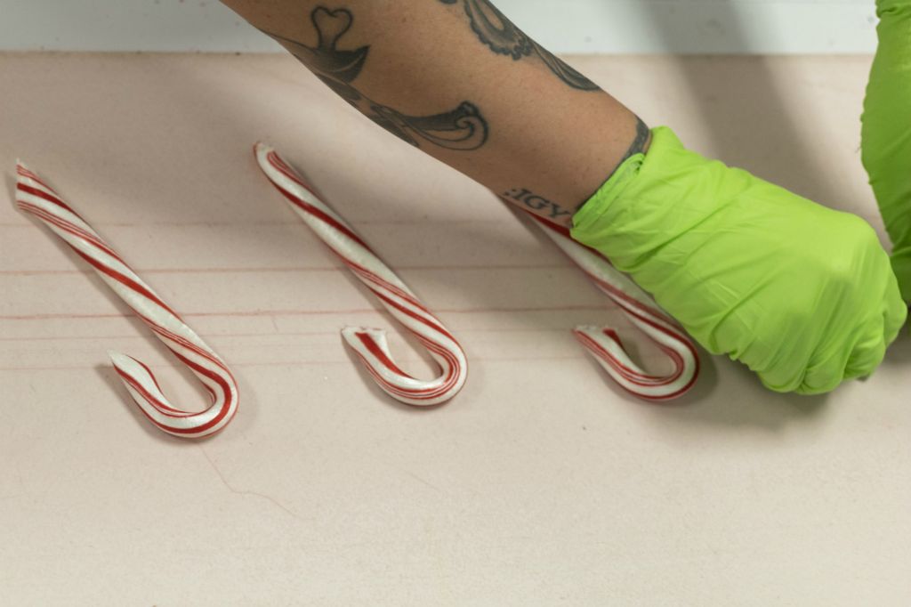 Zoe Cranfill / Ohio UniversityA candy cane “hooker” hooks canes at the Doscher’s Candy Co. Factory in Newtown, Ohio. To become a “hooker” at Doschers you have to have skill and patience to be able to hook the canes so fast. There is 50 canes on average hooked every minute. 