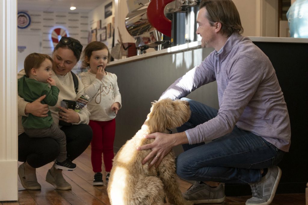 Zoe Cranfill / Ohio UniversityJohn Nielson shows customers of Doschers Candy Co. his dog Telluride on Nov. 22, 2022. Customers love to meet the families who run the company, and hear their story. 