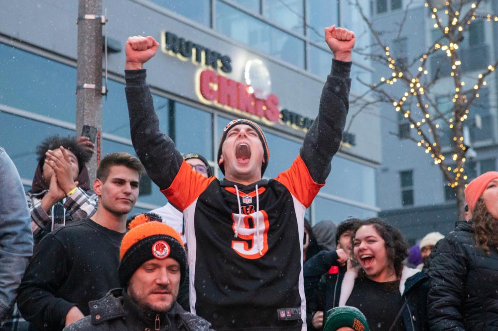 Zoe Cranfill / Ohio UniversityA Bengals fan cheers as the Cincinnati Bengals score a touchdown in the Super Bowl LVI iagainst the Los Angeles Rams on February 13, 2022. The fan watches the game from Marian Spencer Way near The Banks. 