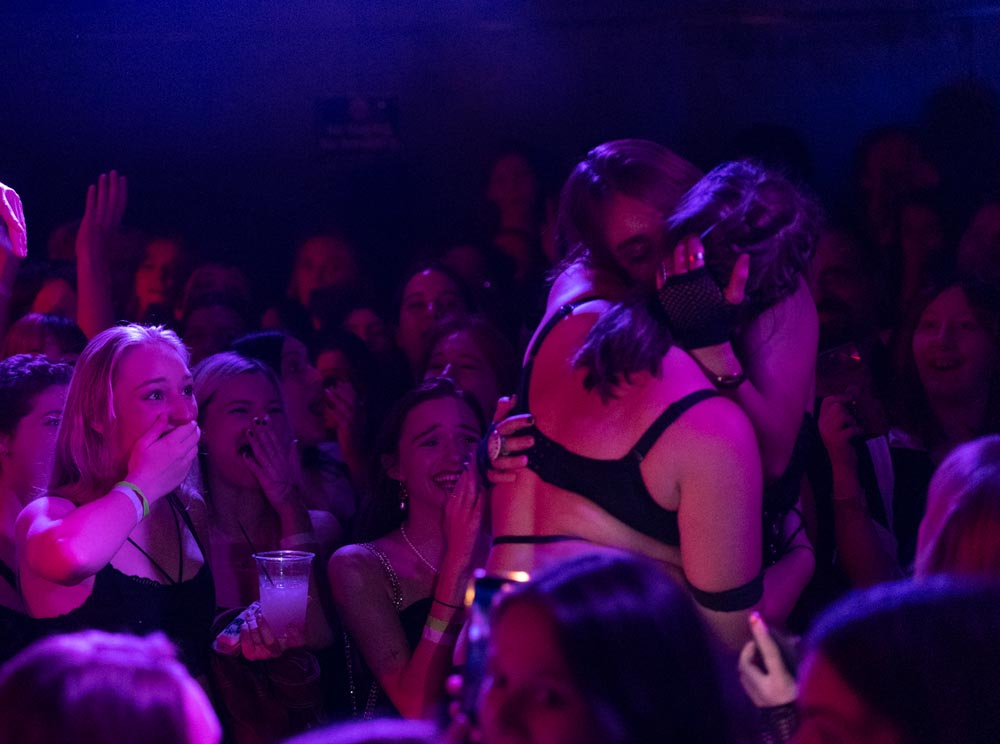 Zoe Cranfill / Ohio UniversityTwo members of the Whorus kiss on stage at the pre-show of The Rocky Horror Picture Show at The Union in Athens, on Oct. 20, 2022. The choreographer and whorus, Lily Boulard, said, “I just say like it's such an encouraging and, like, accepting vibe.”