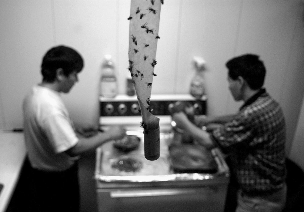 Award of Excellence, Assigned Feature - Bob DeMay / Akron Beacon JournalGuillermo and Santos prepare dinner at their apartment where living conditions are less than ideal by American standards.