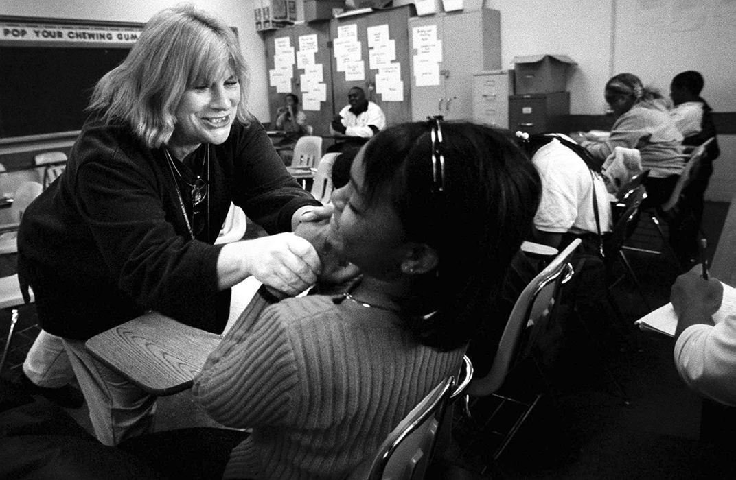 First Place, Feature Picture Story - Steven M. Herppich / Cincinnati EnquirerSandy Houck tries to get Denise Duskin to do her work during English class at Robert A. Taft High School in the West End. Sandy Houck's 9th/10th grade English class is for students who failed 9th grade English and need to pass this class to get credit for both years. 